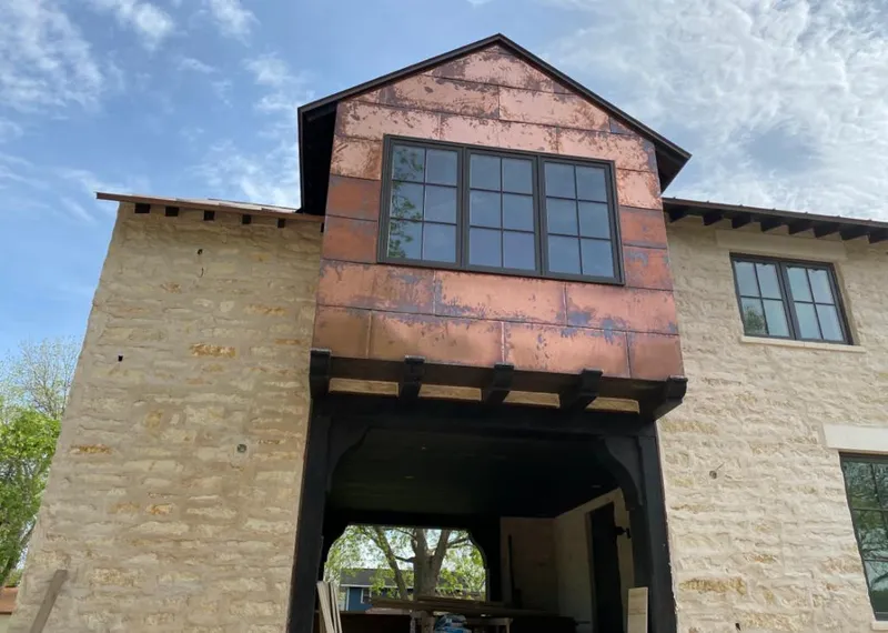 Copper metal panel facade on a stone building for Skylight Installation in Key Largo